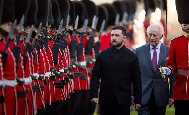 Centre from left: Ukraine's President Volodymyr Zelenskyy, King Charles III and Major Ben Tracey inspecting a guard of honour at Windsor Castle, England, Friday, Oct, 24, 2025. (Aaron Chown/Pool Photo via AP)