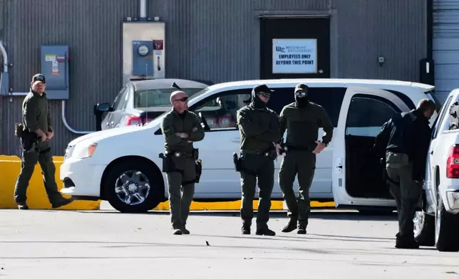Federal Patrol agents stand outside an ICE processing facility in the Chicago suburb of Broadview, Ill., Tuesday, Oct. 21, 2025. (AP Photo/Nam Y. Huh)