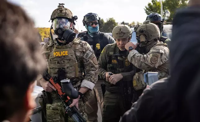 U.S. Border Patrol Commander-At-Large Gregory Bovino stands with federal immigration enforcement agents during a skirmish with protesters in Little Village neighborhood, Chicago Thursday, Oct. 23, 2025. (Ashlee Rezin/Chicago Sun-Times via AP)