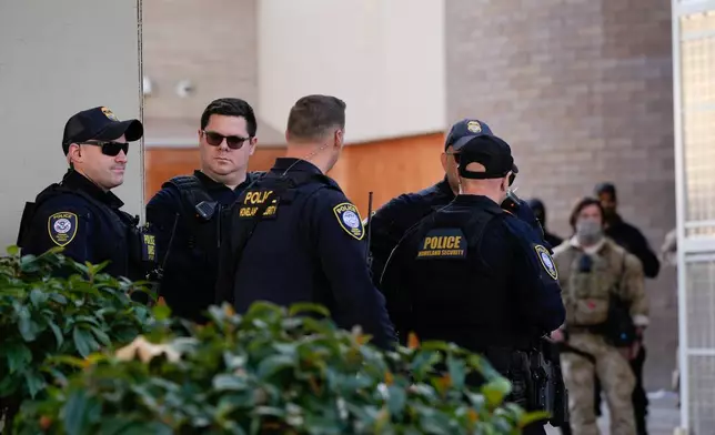 Law enforcement officers are seen outside a United States Immigration and Customs Enforcement (ICE) facility in Portland, Ore., Monday, Oct. 20, 2025. (AP Photo/Jenny Kane)