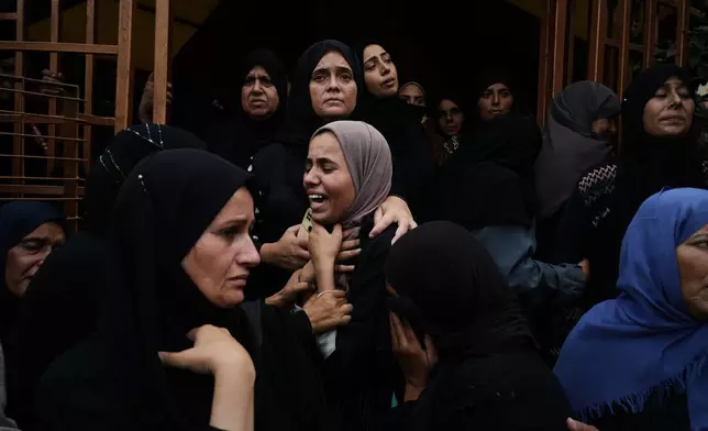 Mourners react during the funeral of their relatives killed in an Israeli army strike, at Nasser Hospital in Khan Younis, Gaza Strip, Wednesday, Oct. 29, 2025. (AP Photo/Jehad Alshrafi)