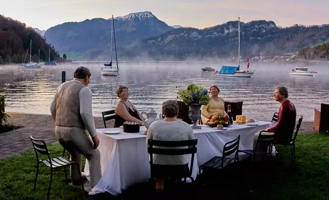 A sculpture by artists Laura and Christel Lechner called "everyday people" decorates a garden of a hotel in Lucerne, Switzerland, Wednesday, Oct. 29, 2025. (AP Photo/Michael Probst)