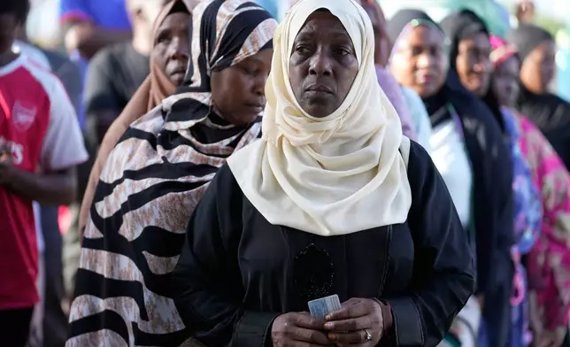 People line up to cast their votes during the general elections at Kwahani polling station in Zanzibar, Tanzania, Wednesday, Oct. 29, 2025. (AP Photo/Brian Inganga)