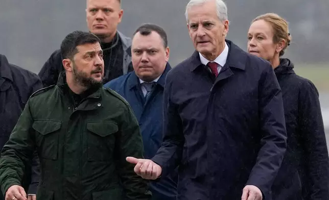 Norway's Prime Minister Jona Gahr Støre, right, welcomes Ukrainian President Volodymyr Zelenskyy on his arrival, at Gardermoen, Norway, Wednesday, Oct. 22, 2025. (Javad Parsa/NTB Scanpix via AP)