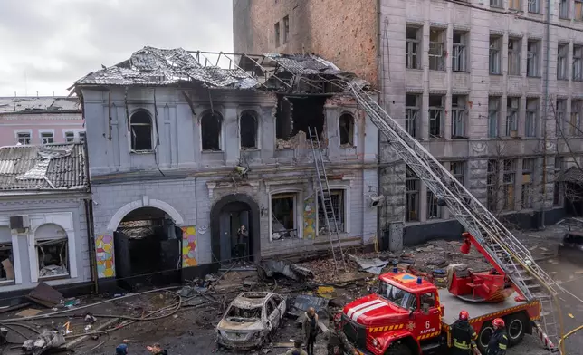 Firefighters put out the fire after Russian drones hit a city kindergarten during an air attack in Kharkiv, Ukraine, Wednesday, Oct. 22, 2025. (AP Photo/Andrii Marienko)