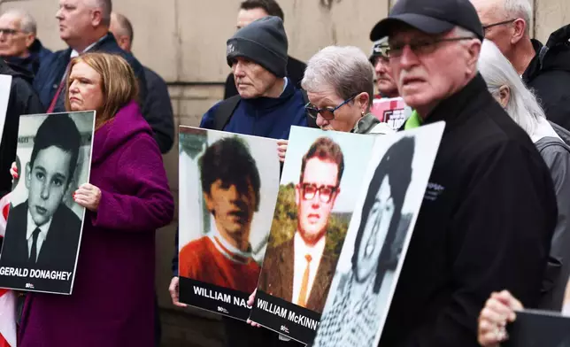 FILE - Families of the victims of the 1972 Bloody Sunday, hold a protest outside Belfast Crown court, Northern Ireland, Monday Sept. 15, 2025. (AP Photo/Peter Morrison, File)