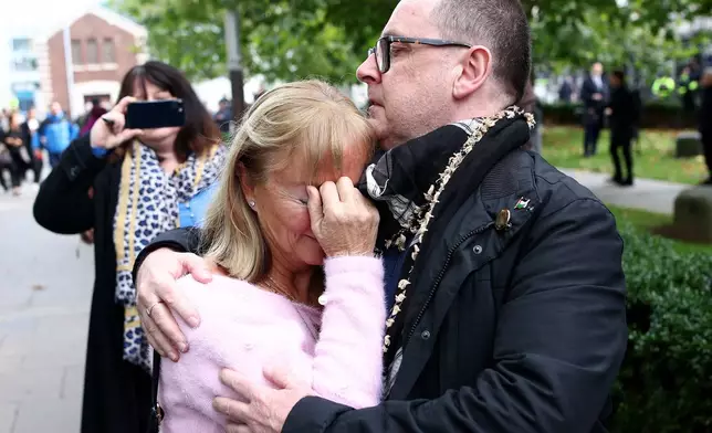 Caroline O'Donnell, left, is comforted outside Belfast Crown Court following the not guilty verdict of the British soldier known as Soldier F in the 1972 Bloody Sunday Massacre Belfast, Northern Ireland, Thursday, Oct. 23, 2025. (AP Photo/Peter Morrison)
