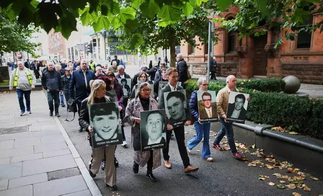 Relatives and supporters of the victims of the 1972 Bloody Sunday massacre march to Belfast Crown Court ahead of the verdict on the trial of a British soldier identified only as Soldier F, Belfast, in Northern Ireland, Thursday, Oct. 23, 2025. (AP Photo/Peter Morrison)