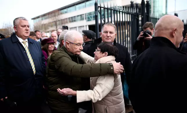 Mickey McKinney, who lost his brother William McKinney in the 1972 Bloody Sunday massacre is comforted outside Belfast Crown Court following the not guilty verdict of British soldier known as Soldier F, Belfast, Northern Ireland, Thursday, Oct. 23, 2025. (AP Photo/Peter Morrison)