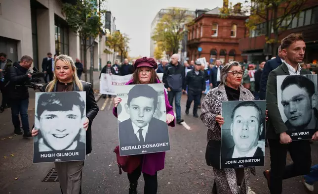 Relatives and supporters of the victims of the 1972 Bloody Sunday massacre march to Belfast Crown Court ahead of the verdict on the trial of a British soldier identified only as Soldier F, Belfast, in Northern Ireland, Thursday, Oct. 23, 2025. (AP Photo/Peter Morrison)
