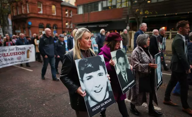 Relatives and supporters of the victims of the 1972 Bloody Sunday massacre march to Belfast Crown Court ahead of the verdict on the trial of a British soldier identified only as Soldier F, Belfast, in Northern Ireland, Thursday, Oct. 23, 2025. (AP Photo/Peter Morrison)