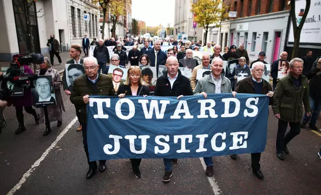 Relatives and supporters of the victims of the 1972 Bloody Sunday massacre march to Belfast Crown Court ahead of the verdict on the trial of a British soldier identified only as Soldier F, Belfast, in Northern Ireland, Thursday, Oct. 23, 2025. (AP Photo/Peter Morrison)