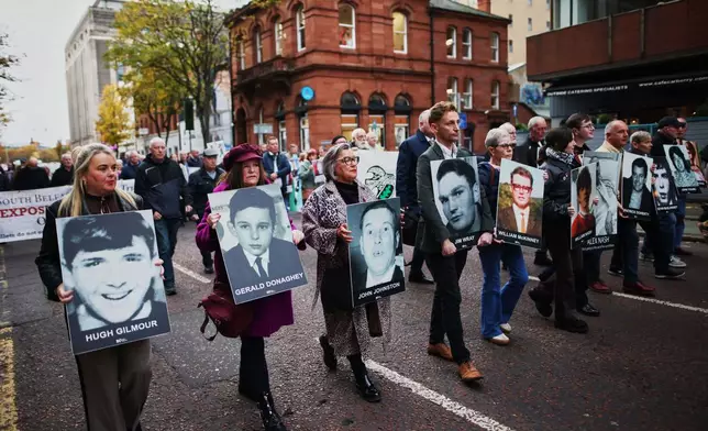 Relatives and supporters of the victims of the 1972 Bloody Sunday massacre march to Belfast Crown Court ahead of the verdict on the trial of a British soldier identified only as Soldier F, Belfast, in Northern Ireland, Thursday, Oct. 23, 2025. (AP Photo/Peter Morrison)