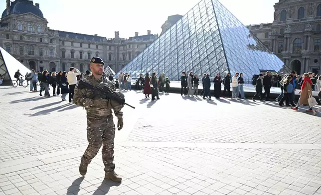 A soldier patrols in courtyard of the Louvre museum, Thursday, Oct. 30, 2025 in Paris. (AP Photo/Emma Da Silva)