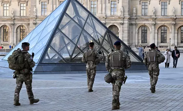 Soldiers patrol in the courtyard of the Louvre museum, Thursday, Oct. 30, 2025 in Paris. (AP Photo/Emma Da Silva)