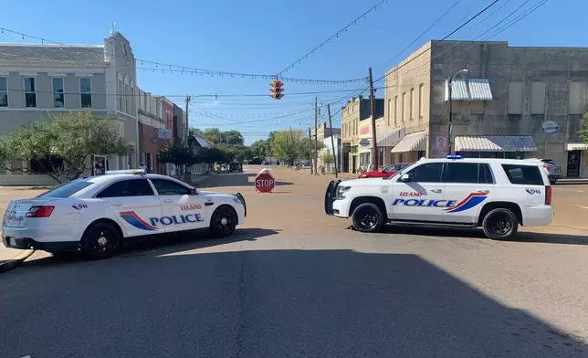 Police vehicles are parked after a deadly shooting Friday night in downtown Leland, Miss.,on Saturday, Oct. 11, 2025. (AP Photo/Katie Adkins)
