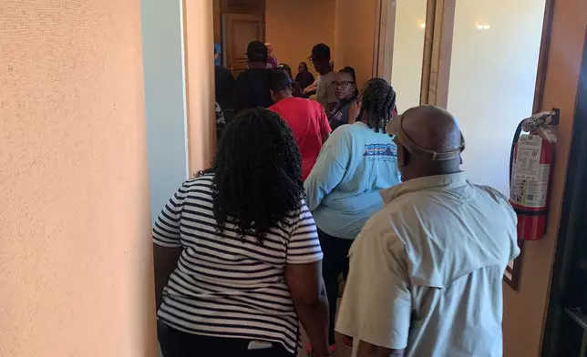 Families of the shooting victims head into a meeting with authorities at Leland City Hall on Saturday, Oct. 11, 2025 in Leland, Miss. (AP Photo/Katie Adkins)