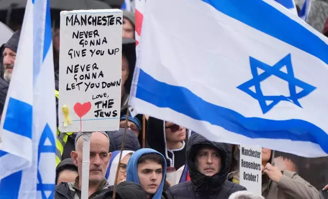People attend a protest outside Manchester Cathedral following an attack at Heaton Park Hebrew Congregation synagogue in Crumpsall, where two people died, in Manchester, England, Sunday Oct. 5, 2025. (Danny Lawson/PA via AP)