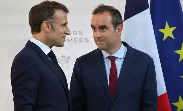 FILE - Then French Defense minister Sebastien Lecornu, right, and France's President Emmanuel Macron talk at the end of an address by the president to army leaders in Paris Sunday July 13, 2025, (Ludovic Marin, Pool via AP, File)
