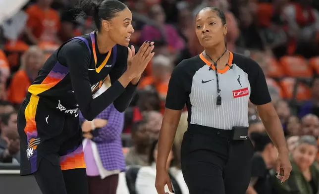 Phoenix Mercury forward DeWanna Bonner (14) talks to WNBA official Fatou Cissoko-Stephens during the first half of Game 3 of the WNBA basketball finals against the Las Vegas Aces, Wednesday, Oct. 8, 2025, in Phoenix. (AP Photo/Rick Scuteri)