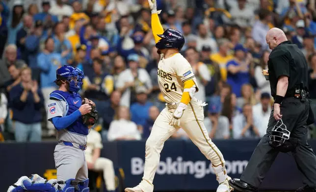 Milwaukee Brewers' William Contreras (24) celebrates while crossing home plate after hitting a solo home run during the third inning of Game 2 of baseball's National League Division Series against the Chicago Cubs Monday, Oct. 6, 2025, in Milwaukee. (AP Photo/Kayla Wolf)
