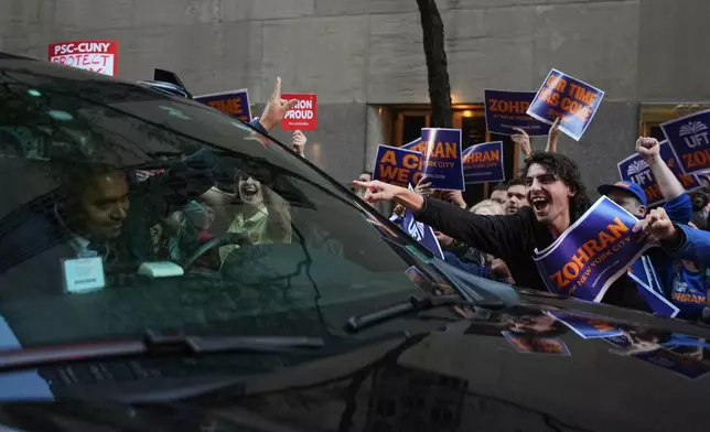 Supporters for Democratic candidate Zohran Mamdani react as a car passes outside NBC Studios before a mayoral debate, Thursday, Oct. 16, 2025, in New York. (AP Photo/Angelina Katsanis)