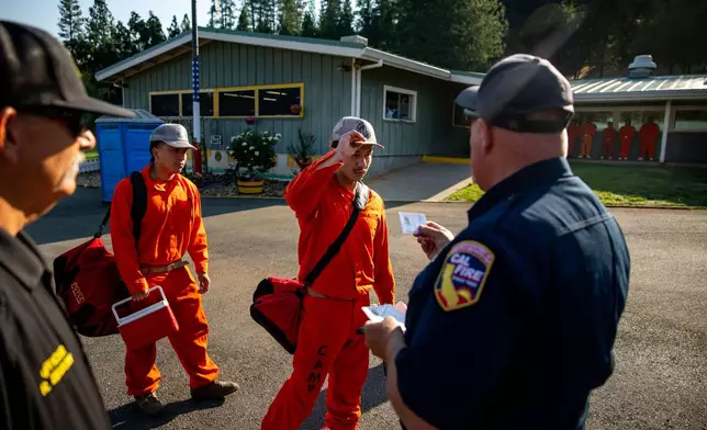 A participant in the Youth Offender Program Camp Pilot Program lines up before work at the Pine Grove Youth Conservation Camp, July 14, 2025, in Red Corral, Calif. (AP Photo/Ethan Swope)