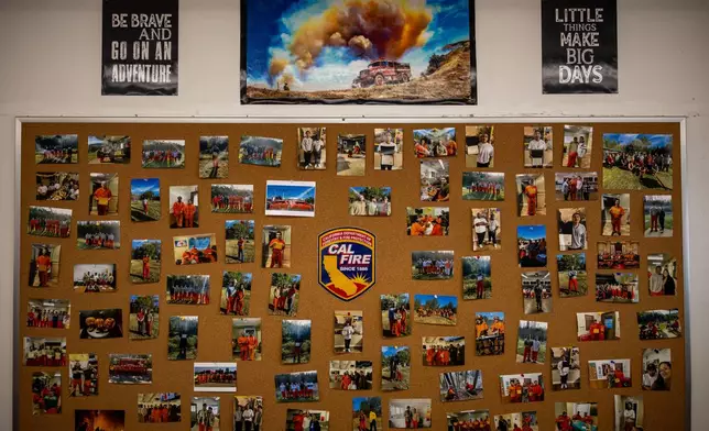 Photos are pinned to a bulletin board at the Pine Grove Youth Conservation Camp, July 14, 2025, in Red Corral, Calif. (AP Photo/Ethan Swope)