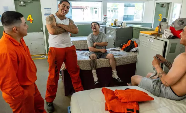 Inmates socialize at the Pine Grove Youth Conservation Camp, July 14, 2025, in Red Corral, Calif. (AP Photo/Ethan Swope)