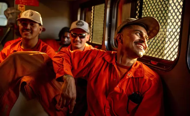 Inmates ride in a vehicle at the Pine Grove Youth Conservation Camp, July 14, 2025, in Red Corral, Calif. (AP Photo/Ethan Swope)