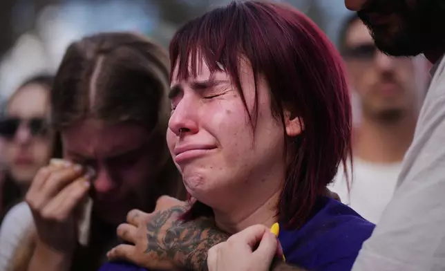 People attend a memorial marking two years anniversary of the deadly Oct. 7, 2023 Hamas attack on Israel, at the site of the Nova music festival where hundreds of revelers were killed and abducted in the assault, near Kibbutz Reim in southern Israel, Tuesday, Oct. 7, 2025. (AP Photo/Ariel Schalit)