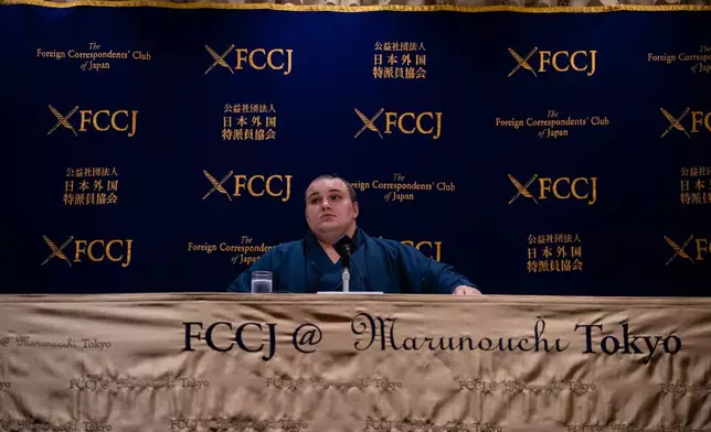 Ukrainian sumo wrestler Danilo Yavhushyshyn, known by his Japanese name Aonishiki Arata, reacts during a press conference at the Foreign Correspondents' Club of Japan, in Tokyo, Thursday, Oct. 9, 2025. (AP Photo/Louise Delmotte)