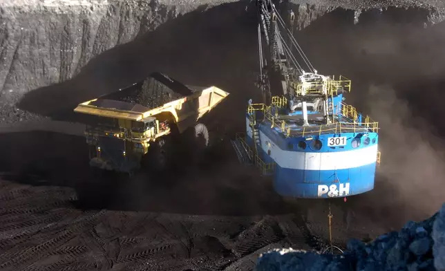 FILE - A haul truck is seen after being loaded with coal by a mechanized shovel at the Spring Creek mine, in this Nov. 15, 2016 photo, near Decker, Mont. (AP Photo/Matthew Brown)