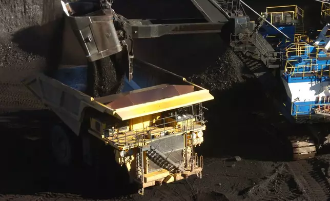 A mechanized shovel loads coal into a haul truck at the Spring Creek mine, in this Nov. 15, 2016 photo, near Decker, Mont. (AP Photo/Matthew Brown)