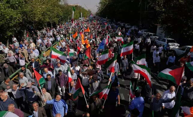 Iranian worshippers hold Iranian and Palestinian flags during an anti-Israeli rally after their Friday prayers at the Enqelab-e-Eslami (Islamic Revolution) street, in Tehran, Iran, Friday, Oct. 10, 2025. (AP Photo/Vahid Salemi)