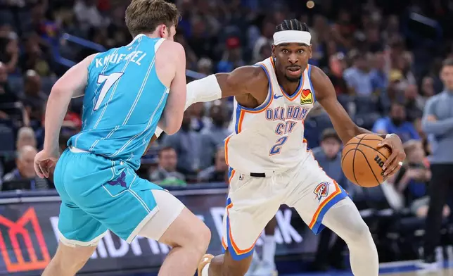 Oklahoma City Thunder guard Shai Gilgeous-Alexander (2) drives against Charlotte Hornets guard Kon Knueppel (7) during the first half of a preseason NBA basketball game Thursday, Oct. 9, 2025, in Oklahoma City. (AP Photo/Nate Billings)
