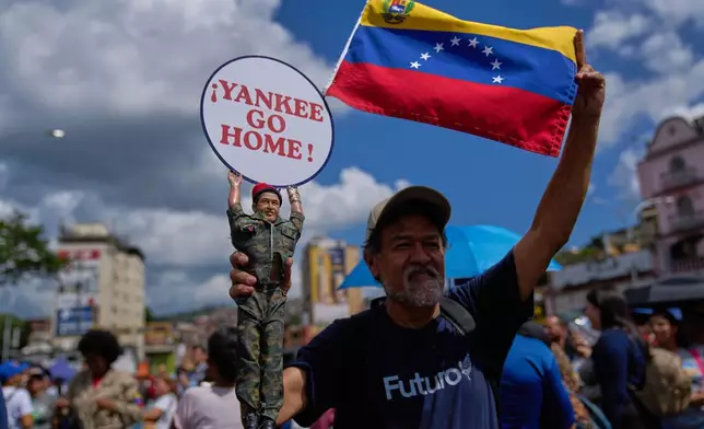 A man holds a doll of late President Hugo Chavez near the United Nations' office in Caracas, Venezuela, during a government-organized rally against foreign interference on Monday, Oct. 6, 2025. (AP Photo/Ariana Cubillos)