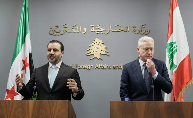 Syrian Foreign Minister Asaad al-Shibani, left, speaks during a briefing for journalists after his meeting with Lebanese Foreign Minister Youssef Rajji, right, in Beirut, Lebanon, Friday, Oct. 10, 2025. (AP Photo/Hassan Ammar)