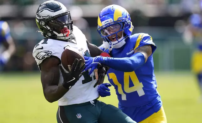 Philadelphia Eagles wide receiver A.J. Brown (11) catches a pass as Los Angeles Rams cornerback Cobie Durant (14) defends during the second half of an NFL football game Sunday, Sept. 21, 2025, in Philadelphia. (AP Photo/Chris Szagola)