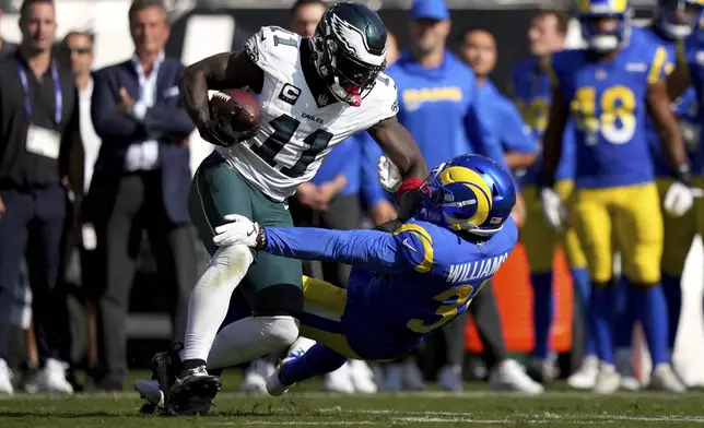 Philadelphia Eagles wide receiver A.J. Brown (11) catches a pass as Los Angeles Rams cornerback Darious Williams (31) defends during the second half of an NFL football game Sunday, Sept. 21, 2025, in Philadelphia. (AP Photo/Matt Slocum)