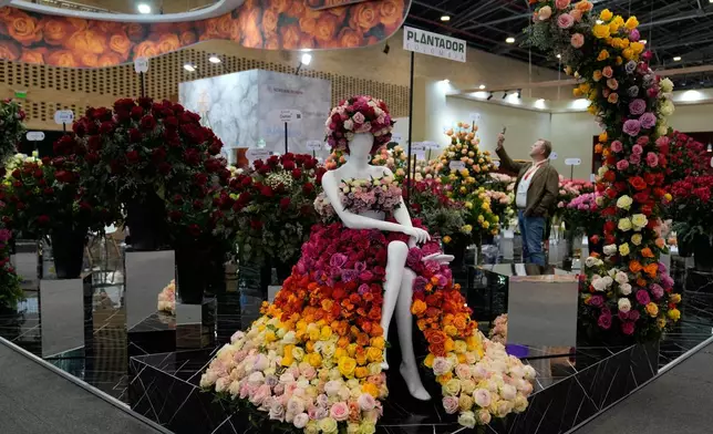 A mannequin wears a dress made out of flowers at Proflora, a biennial fair showcasing international floral trends, in Bogota, Colombia, Wednesday, Oct. 1, 2025. (AP Photo/Fernando Vergara)