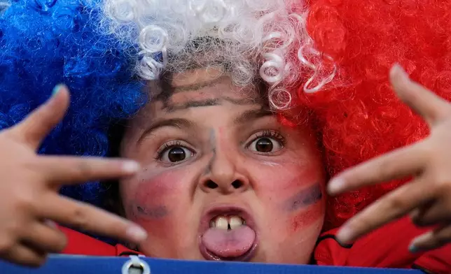 A child poses for a photo prior to a FIFA U-20 World Cup Group A soccer match between Chile and New Zealand at National Stadium in Santiago, Chile, Saturday, Sept. 27, 2025. (AP Photo/Matias Delacroix)