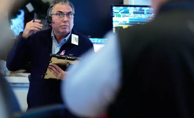 John Bishop works on the floor at the New York Stock Exchange in New York, Wednesday, Oct. 1, 2025. (AP Photo/Seth Wenig)