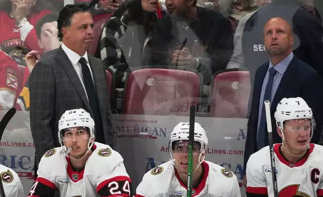 Ottawa Senators center Dylan Cozens (24) and left wing David Perron (57) look up at the scoreboard during the third period of an NHL hockey game against the Florida Panthers, Saturday, Oct. 11, 2025, in Sunrise, Fla. (AP Photo/Marta Lavandier)
