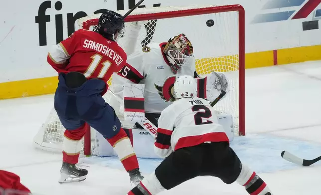 Florida Panthers right wing Mackie Samoskevich (11) scores a goal against Ottawa Senators goaltender Linus Ullmark (35) during the third period of an NHL hockey game, Saturday, Oct. 11, 2025, in Sunrise, Fla. (AP Photo/Marta Lavandier)