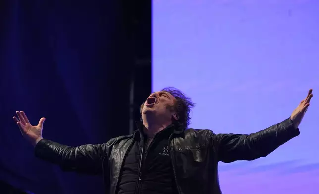 President Javier Milei sings during at a rally for his party's candidates ahead of the upcoming midterm elections, in Rosario, Argentina, Thursday, Oct. 23, 2025. (AP Photo/Rodrigo Abd)