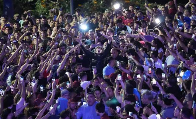 President Javier Milei joins the crowd during a rally in support of his party's candidates ahead of the upcoming midterm elections, in Rosario, Argentina, Thursday, Oct. 23, 2025. (AP Photo/Rodrigo Abd)