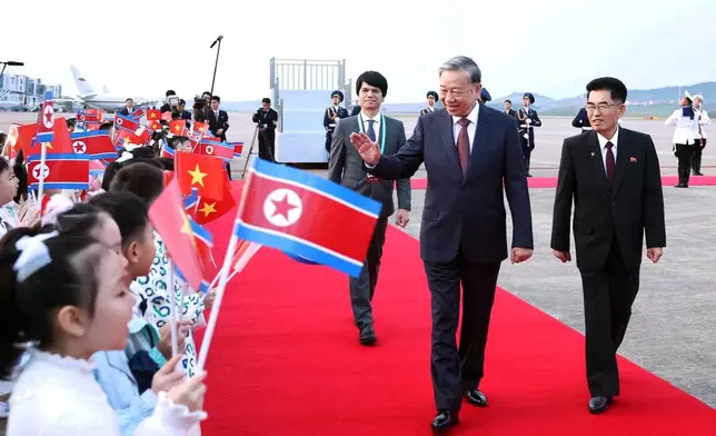 Vietnamese General Secretary of Communist Party To Lam, second right, is greeted by children upon his arrival in Pyongyang, North Korea, Thursday, Oct. 9, 2025, for a state visit and to attend the 80th anniversary of the founding of North Korea's ruling Worker's Party of Korea. (Hoang Thong Nhat/VNA via AP)