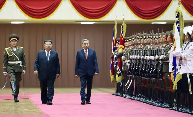 North Korean leader Kim Jong Un, second left, and Vietnamese General Secretary of Communist Party To Lam, third left, review honor guards during a welcome ceremony for Lam's state visit in Pyongyang, North Korea, Thursday, Oct. 9, 2025. (Hoang Thong Nhat/VNA via AP)