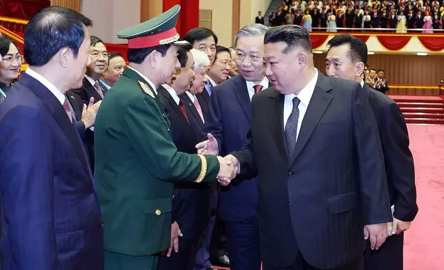 North Korean leader Kim Jong Un. front right, shakes hands with Vietnamese Defense Minister Phan Van Giang in Pyongyang, North Korea, Thursday, Oct. 9, 2025. (Hoang Thong Nhat/VNA via AP)